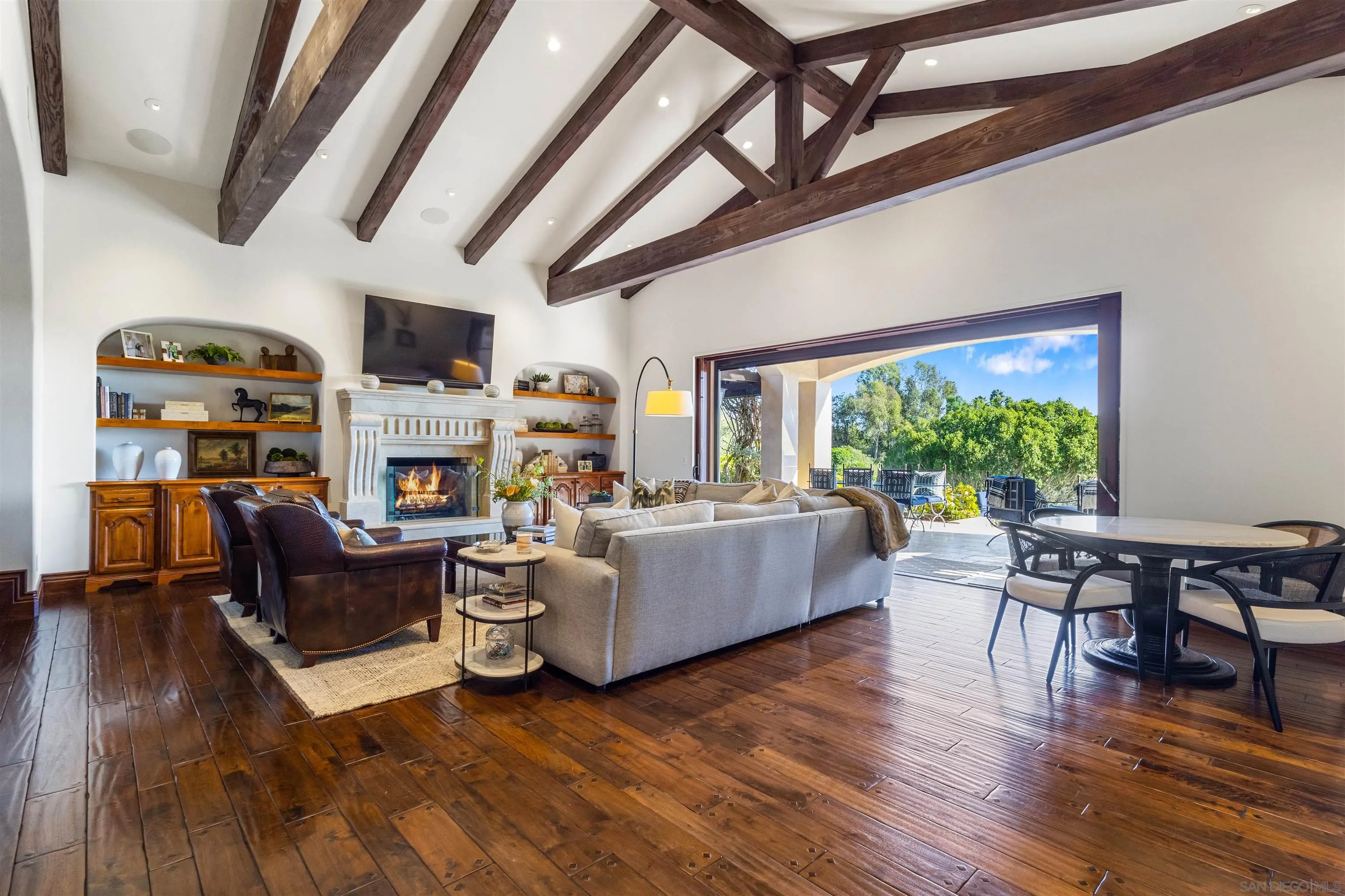 6871 Las Colinas Rancho Santa Fe, CA 92067 - Photo 19 of 60 a living room with furniture a fireplace a flat screen tv and a large window