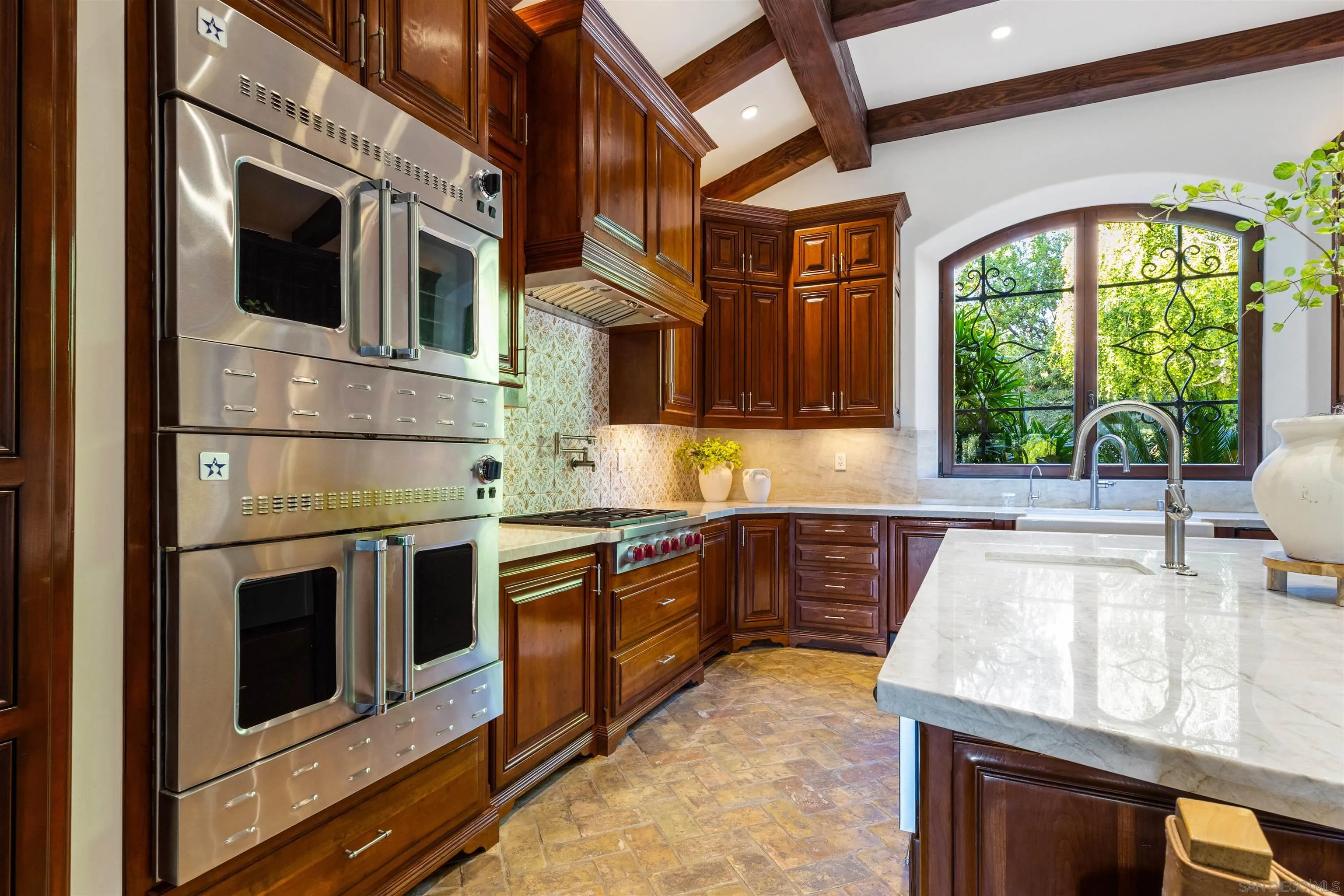 6871 Las Colinas Rancho Santa Fe, CA 92067 - Photo 21 of 60 a kitchen with stainless steel appliances granite countertop a stove and a microwave