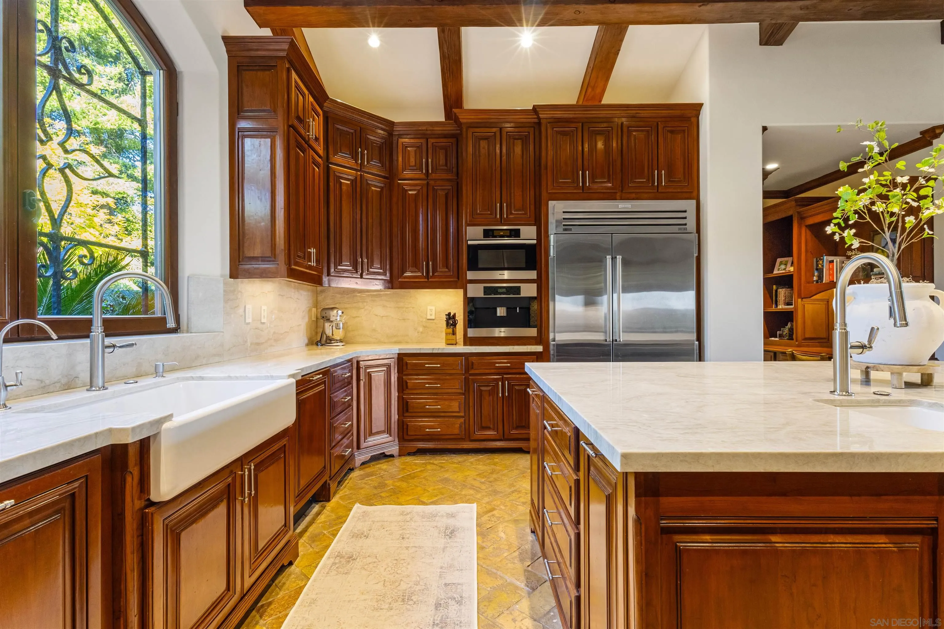 6871 Las Colinas Rancho Santa Fe, CA 92067 - Photo 22 of 60 a kitchen with kitchen island granite countertop a sink stove and cabinets