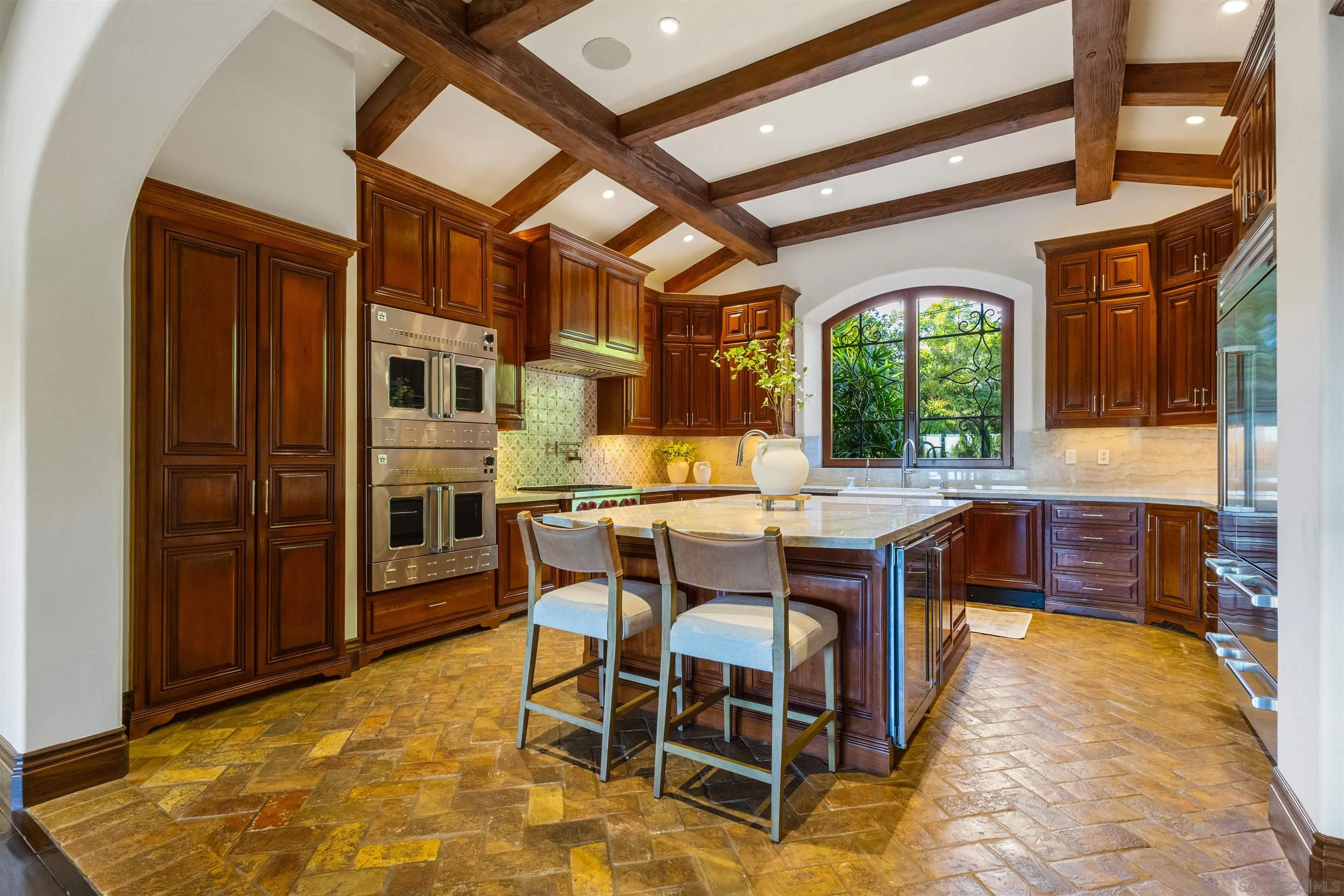 6871 Las Colinas Rancho Santa Fe, CA 92067 - Photo 24 of 60 a dining hall with stainless steel appliances granite countertop a stove a sink a dining table and chairs with wooden floor