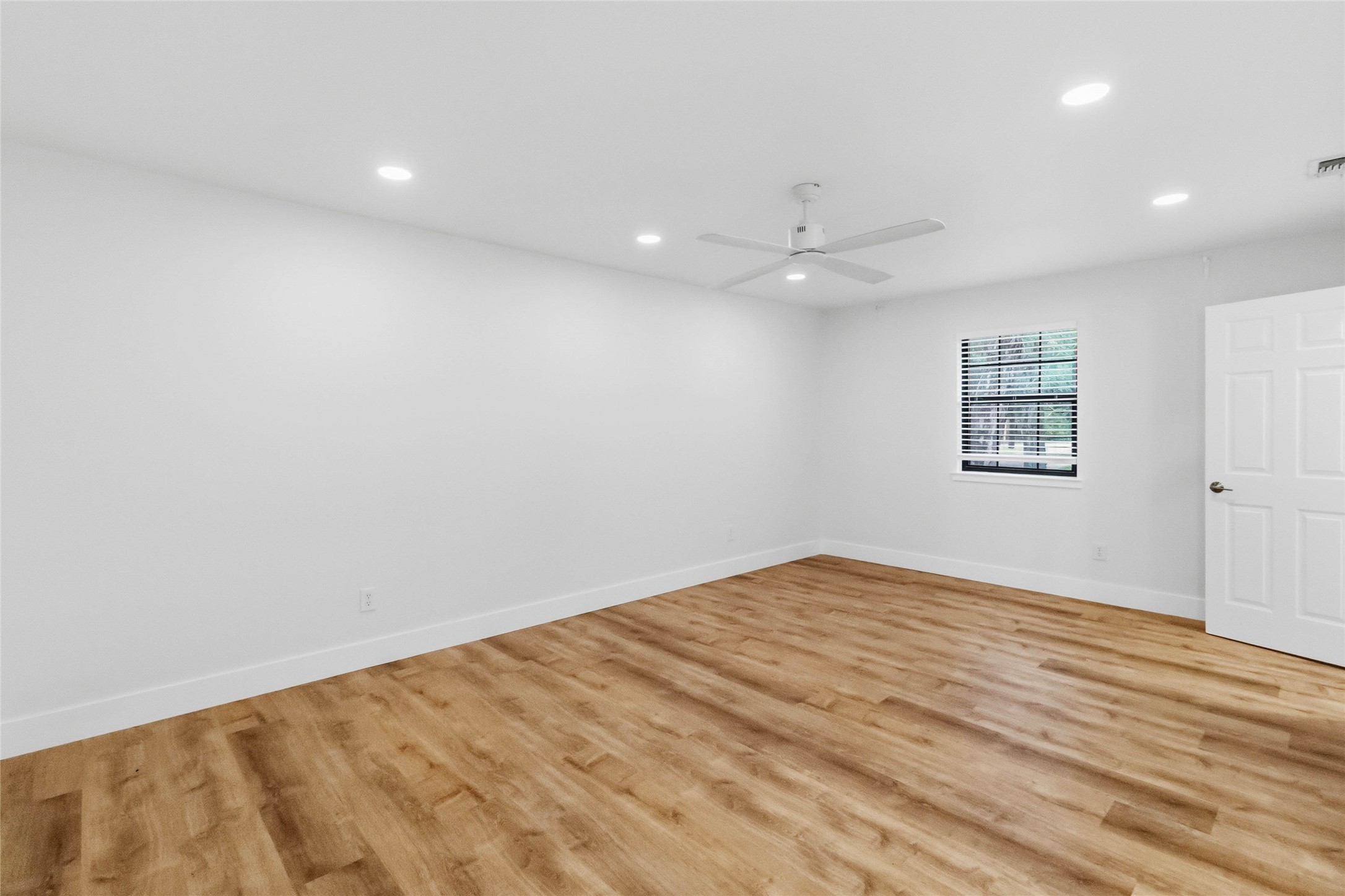 326 Pine View Loop Bastrop, TX 78602 - Photo 24 of 30 Hardwood floors and bright recessed lighting create a peaceful atmosphere in this bedroom.