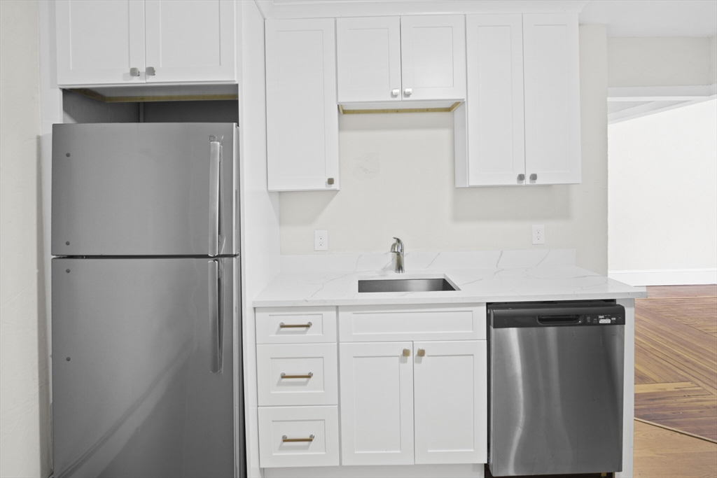 10 Redfield Street, Unit 2 Boston, MA 02122 - Photo 9 of 10 a kitchen with white cabinets and refrigerator