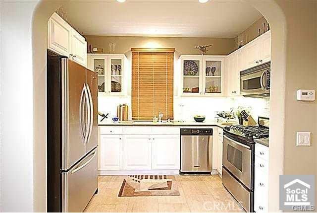 95 Windchime Irvine, CA 92603 - Photo 2 of 8 a kitchen with stainless steel appliances granite countertop a refrigerator a stove a sink and a microwave