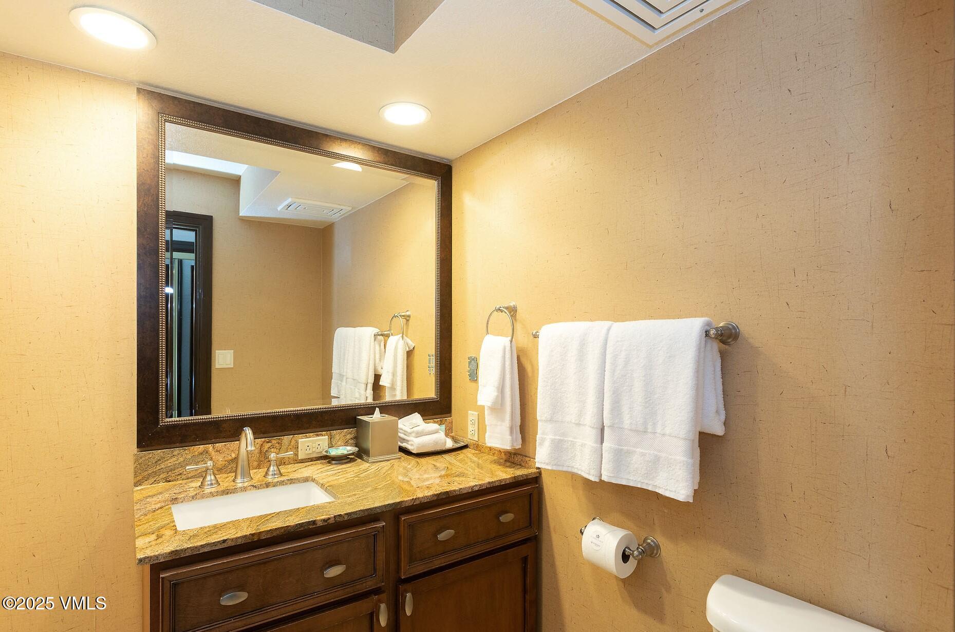 210 Offerson Road, Unit R315 WEEK 14 Beaver Creek, CO 81620 - Photo 15 of 31 a bathroom with a granite countertop sink and a mirror