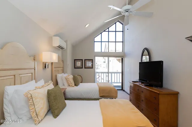 a living room with furniture a flat screen tv and a window