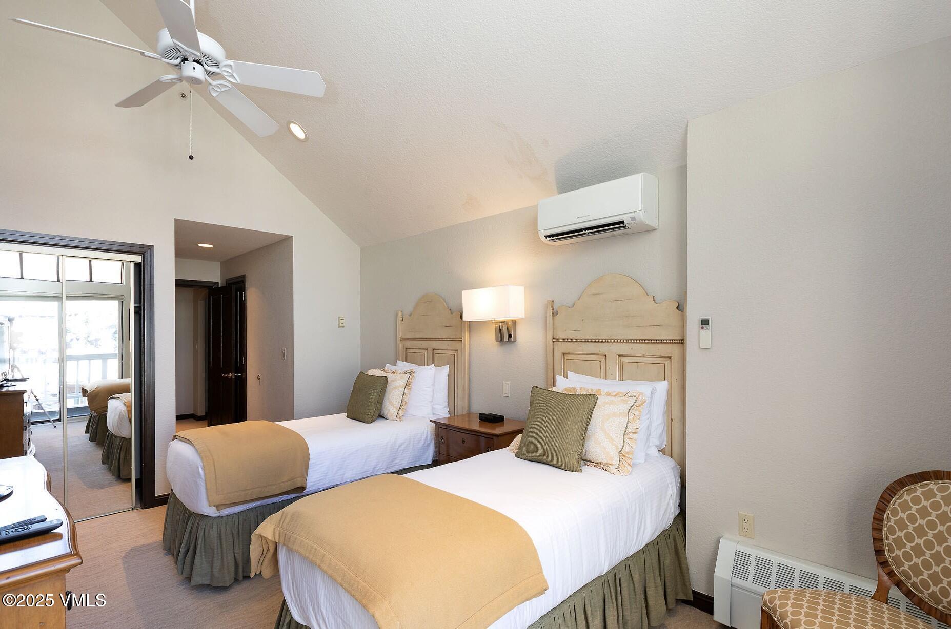 210 Offerson Road, Unit R315 WEEK 14 Beaver Creek, CO 81620 - Photo 18 of 31 a bedroom with two beds and painting on the wall