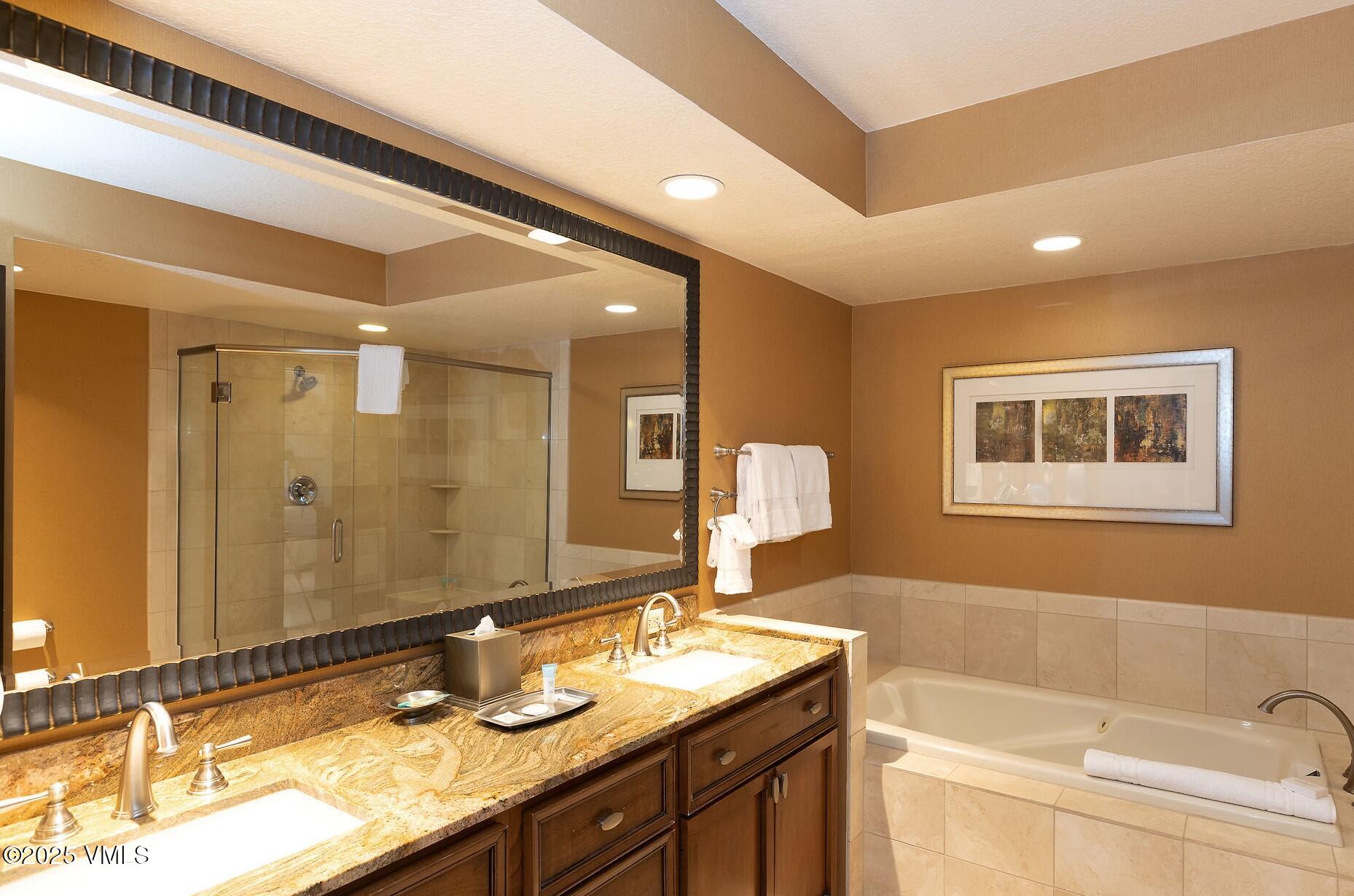 210 Offerson Road, Unit R315 WEEK 14 Beaver Creek, CO 81620 - Photo 29 of 31 a bathroom with a granite countertop sink mirror and a