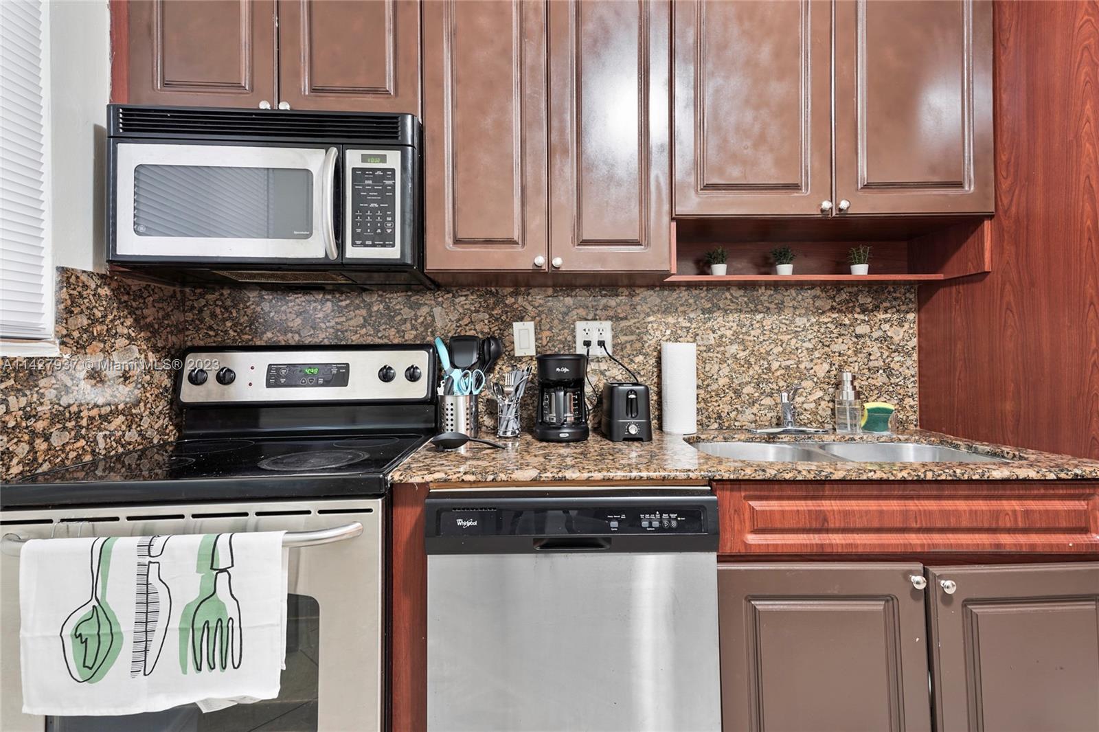 828 Southwest 2nd Street Miami, FL 33130 - Photo 11 of 13 a kitchen with a stove and a microwave