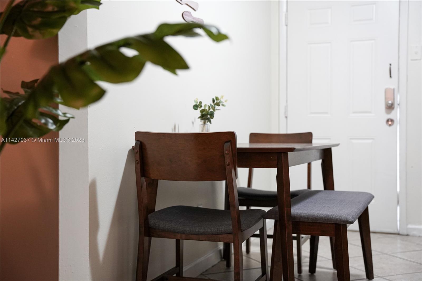 828 Southwest 2nd Street Miami, FL 33130 - Photo 12 of 13 a view of a dining room with furniture and wooden floor