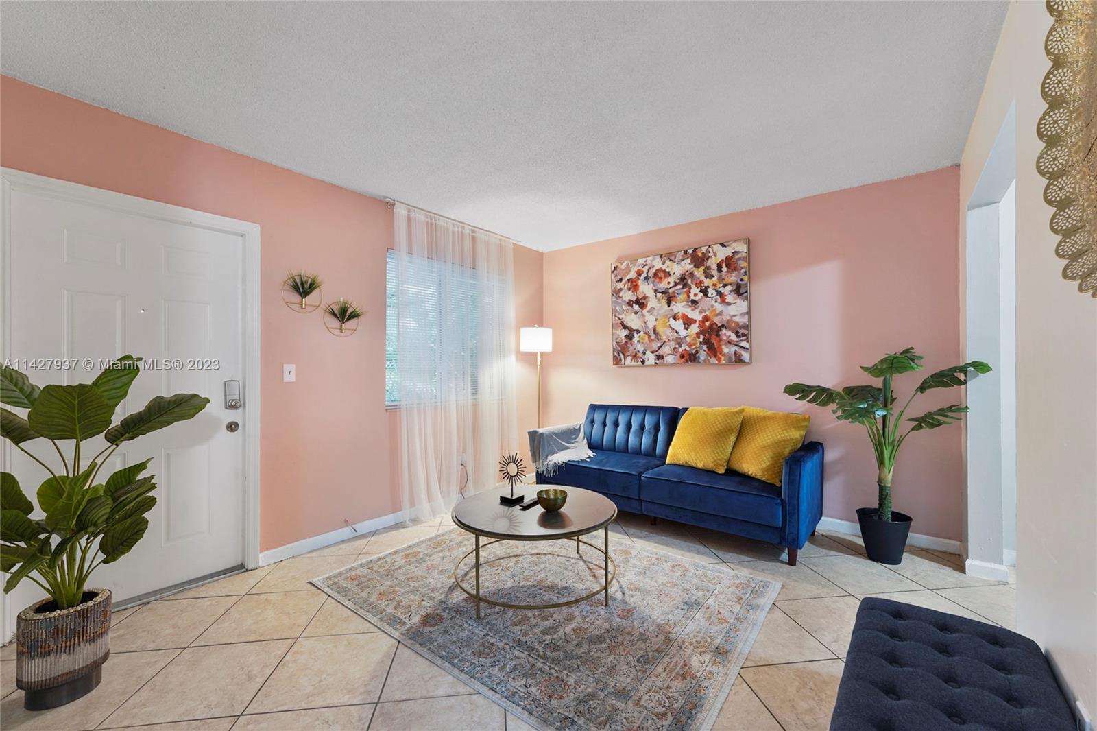 828 Southwest 2nd Street Miami, FL 33130 - Photo 5 of 13 a living room with furniture and a potted plant