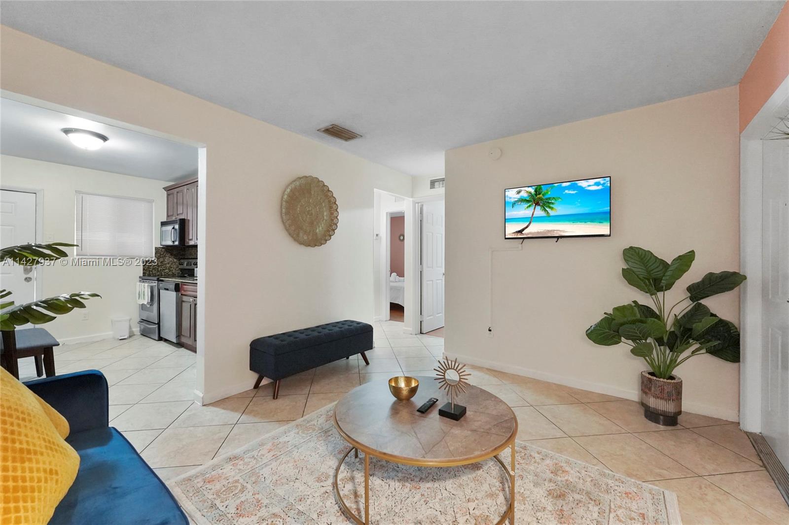 828 Southwest 2nd Street Miami, FL 33130 - Photo 6 of 13 a living room with furniture potted plant and a wooden floor
