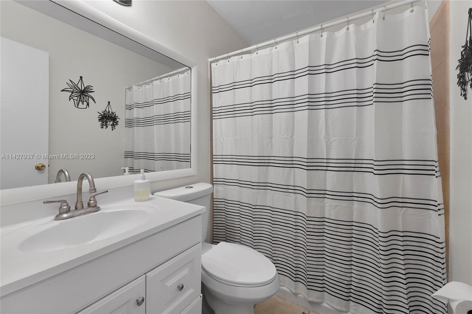 828 Southwest 2nd Street Miami, FL 33130 - Photo 7 of 13 a bathroom with a sink a toilet and shower