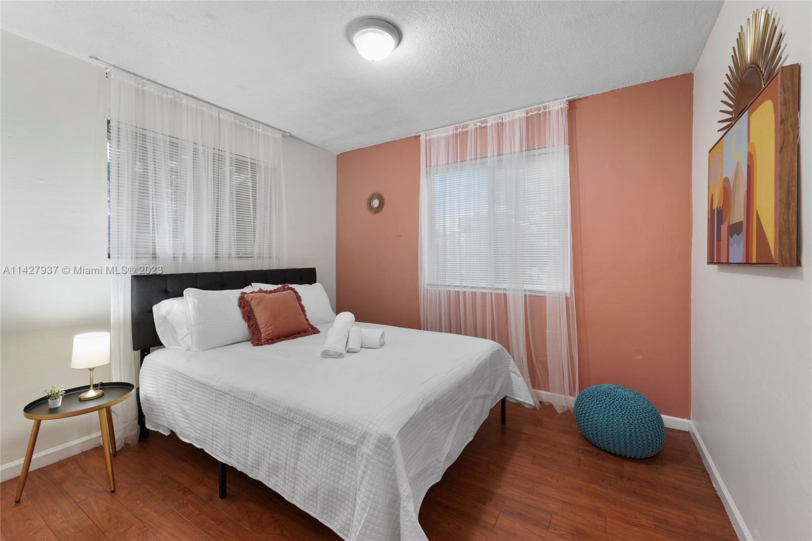 828 Southwest 2nd Street Miami, FL 33130 - Photo 8 of 13 a bedroom with a bed and a window