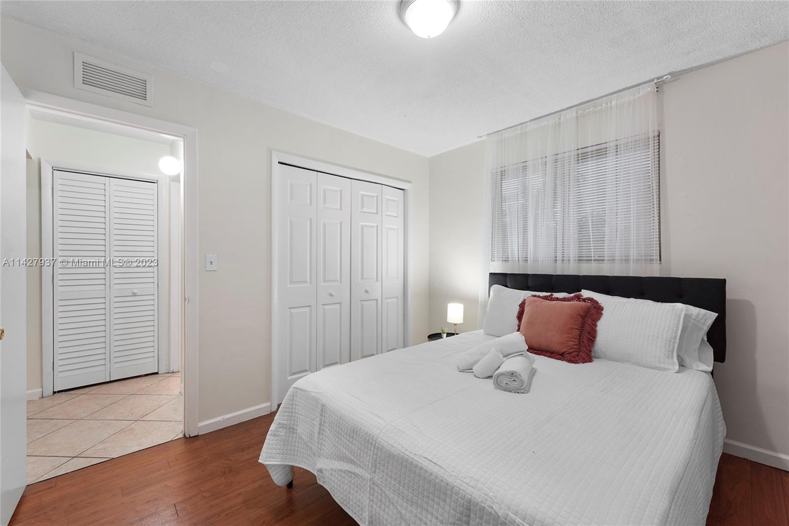 828 Southwest 2nd Street Miami, FL 33130 - Photo 9 of 13 a bedroom with a bed and wooden floor