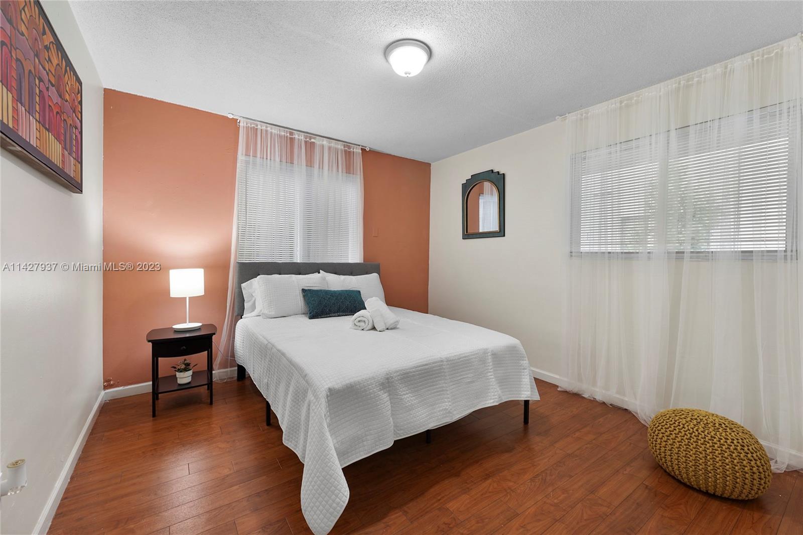 828 Southwest 2nd Street Miami, FL 33130 - Photo 10 of 13 a bedroom with a bed and wooden floor
