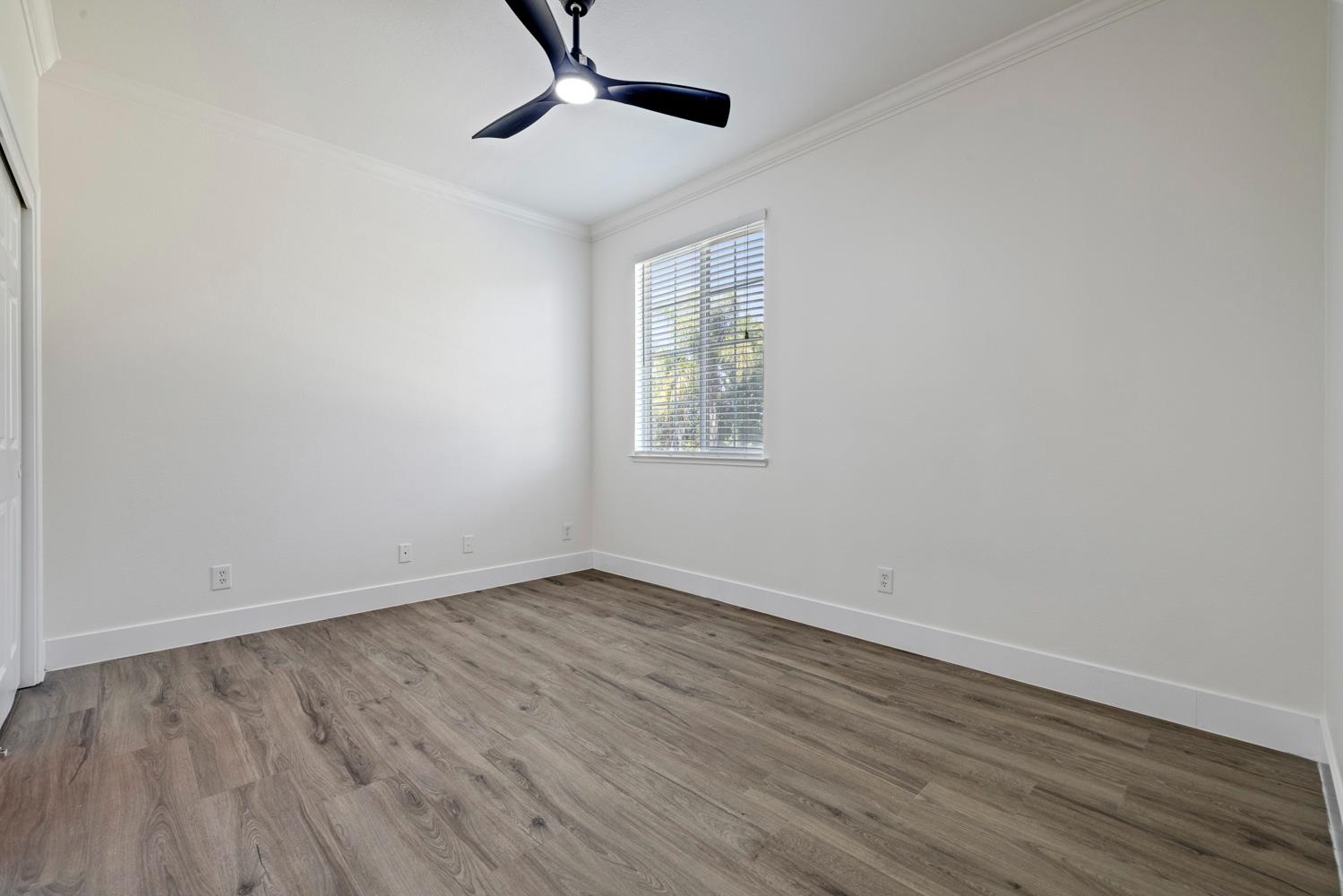 3105 Ripple Court Modesto, CA 95355 - Photo 32 of 46 a view of an empty room with wooden floor and a window