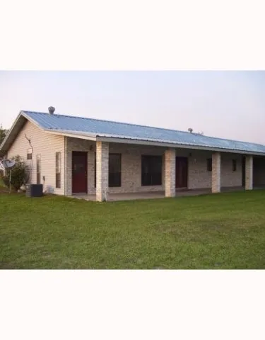 a view of a house with a backyard
