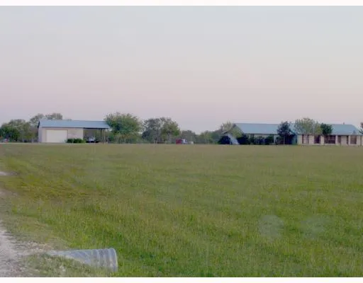 a view of a lake with houses in the back