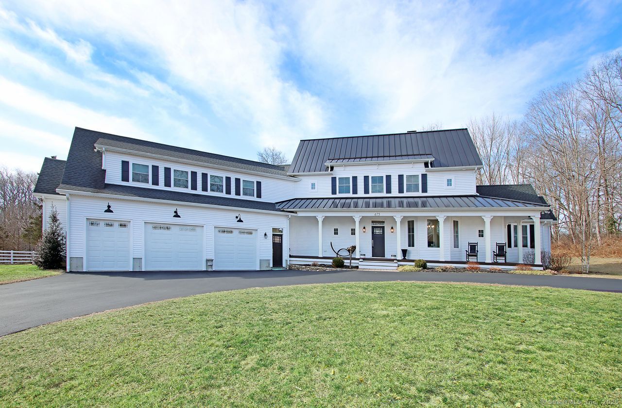 a view of a house with a big yard and large trees