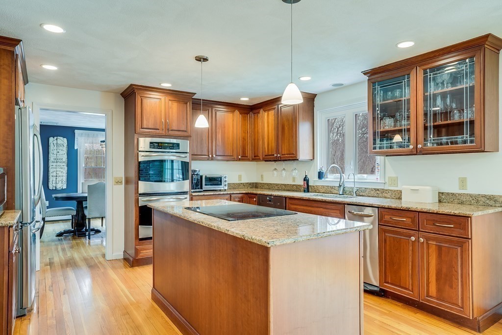 44 Glendale Road Boxford, MA 01921 - Photo 7 of 42 a kitchen with stainless steel appliances granite countertop wooden cabinets a sink a stove a refrigerator and island