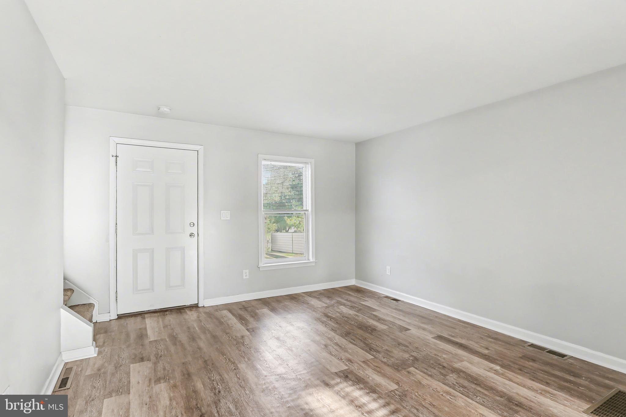 143 15th Street, Unit 3 New Cumberland, PA 17070 - Photo 3 of 10 an empty room with wooden floor and window