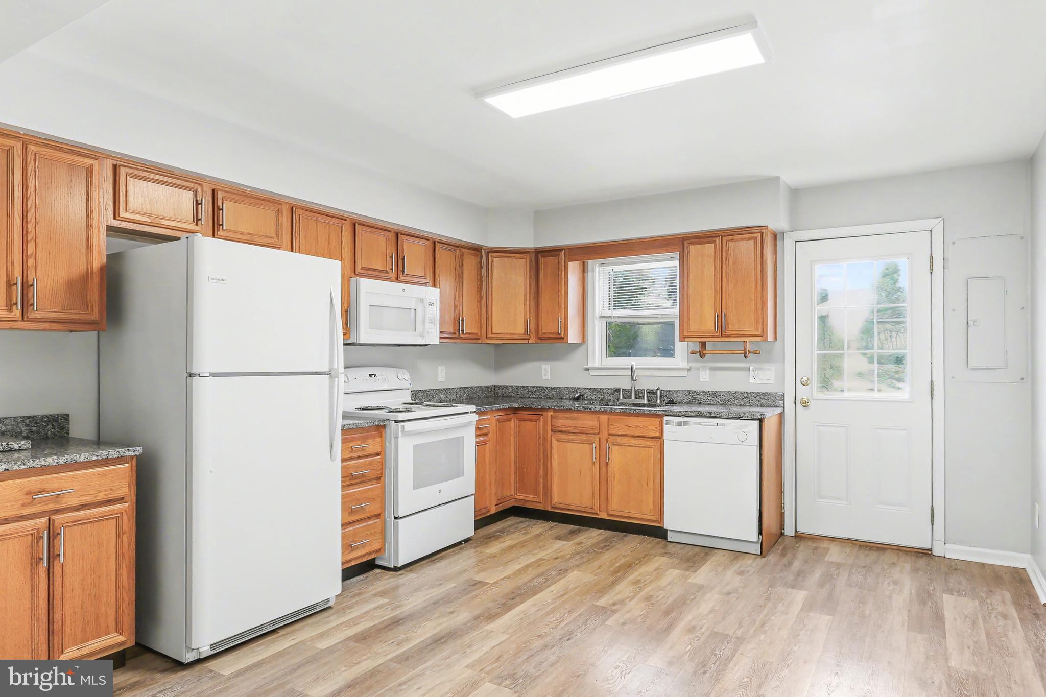 143 15th Street, Unit 3 New Cumberland, PA 17070 - Photo 5 of 10 a kitchen with granite countertop stainless steel appliances a refrigerator sink and microwave