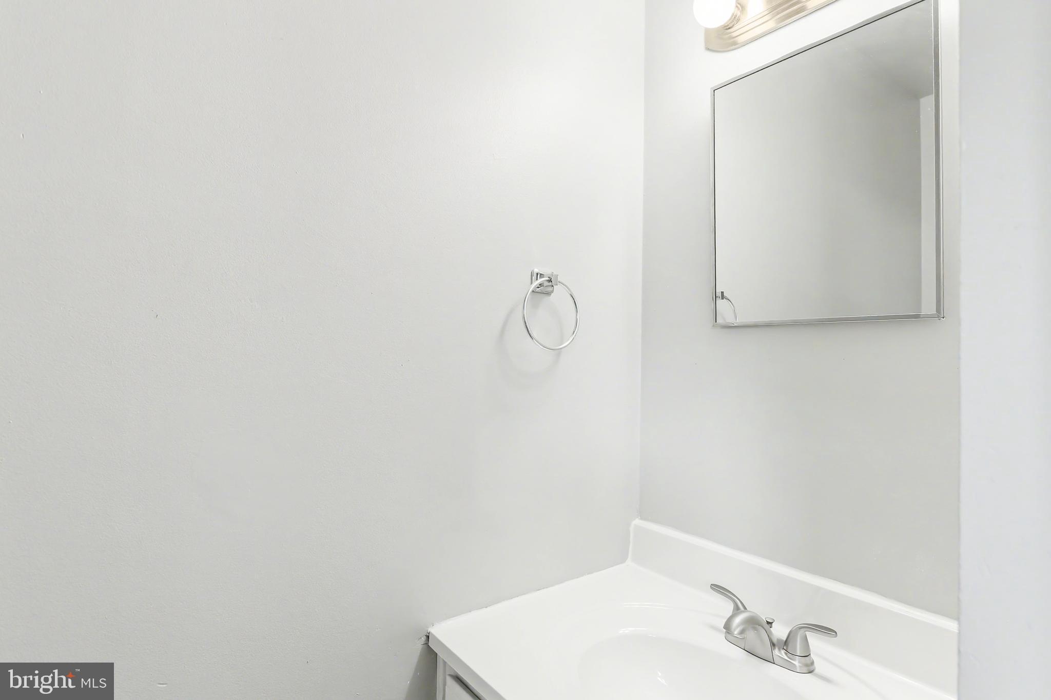 143 15th Street, Unit 3 New Cumberland, PA 17070 - Photo 6 of 10 a bathroom with a sink and mirror