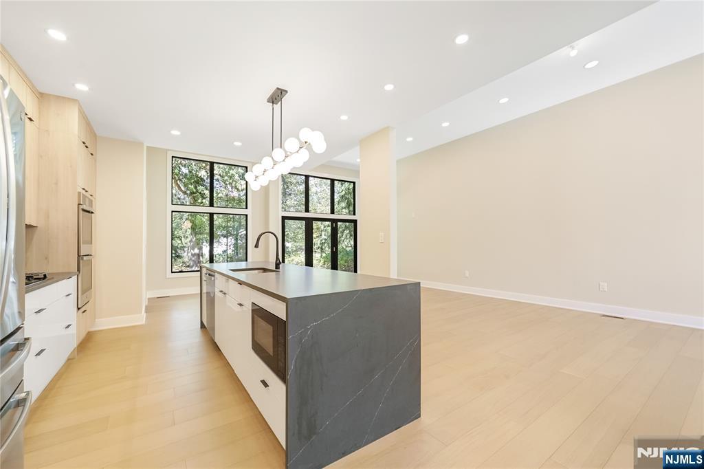 314 Meadowbrook Road Wyckoff, NJ 07481 - Photo 15 of 22 a large white kitchen with a large window