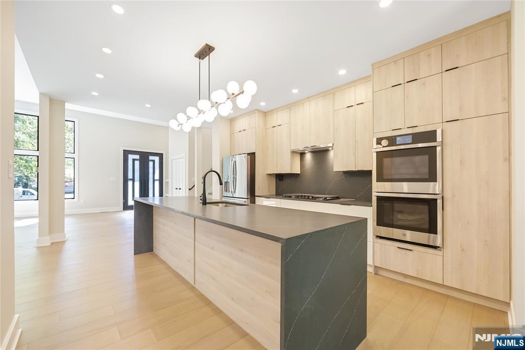 314 Meadowbrook Road Wyckoff, NJ 07481 - Photo 17 of 22 a large kitchen with kitchen island a sink stainless steel appliances and cabinets
