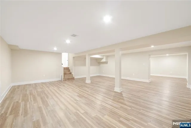 a view of a balcony with wooden floor and iron fence