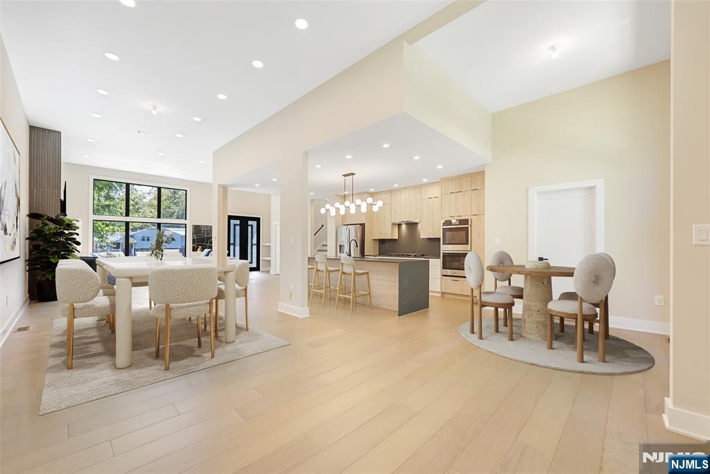 314 Meadowbrook Road Wyckoff, NJ 07481 - Photo 7 of 22 a dining room with furniture a table and kitchen view