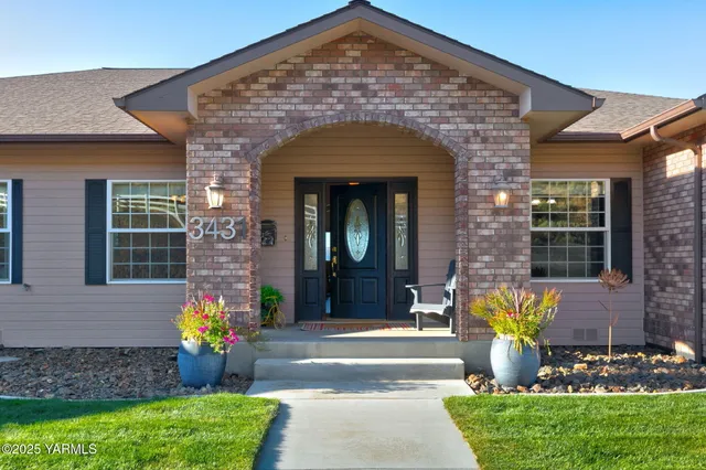 a front view of a house with outdoor seating