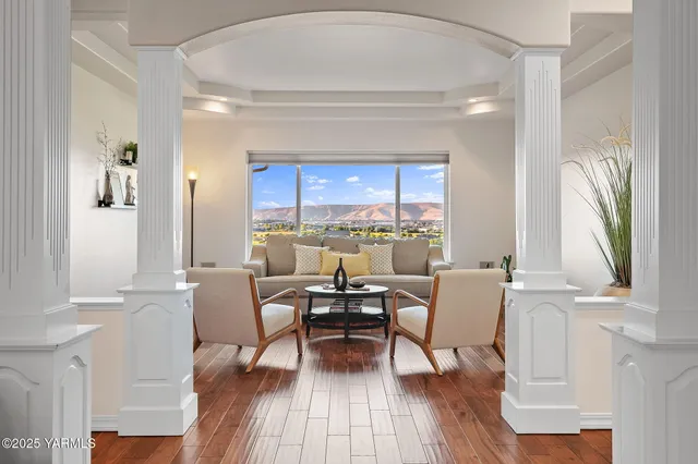 a dining room with furniture a window and wooden floor