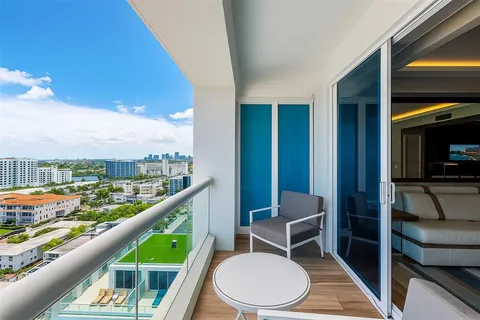 a balcony with wooden floor and furniture