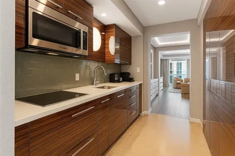 a kitchen with stainless steel appliances a stove microwave and cabinets