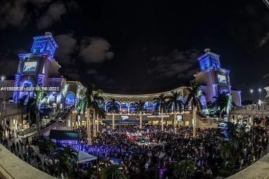 a view of a building with cars park in front of it