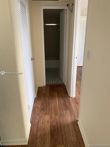 a view of a hallway and wooden floor