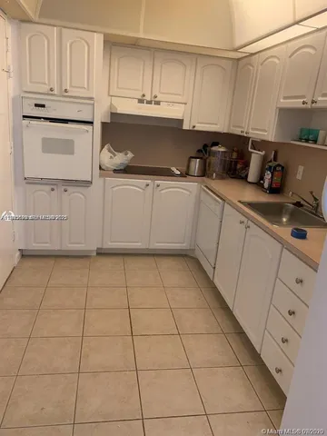 a kitchen with cabinets and appliances