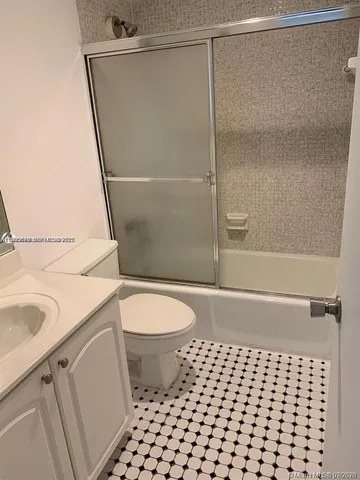 a bathroom with a toilet a sink and a shower
