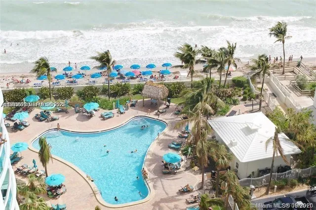 a view of a tall building next to a yard