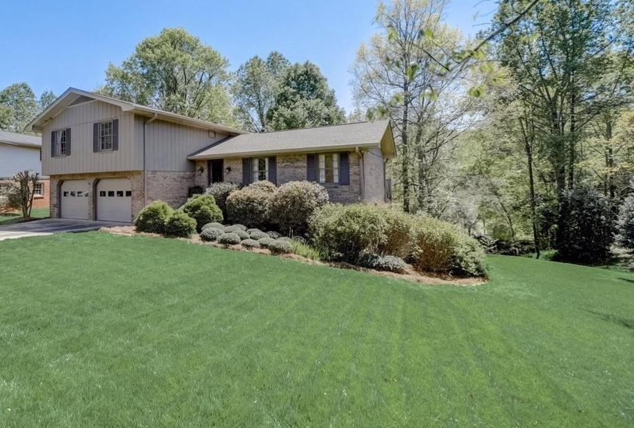 a front view of house with yard and green space