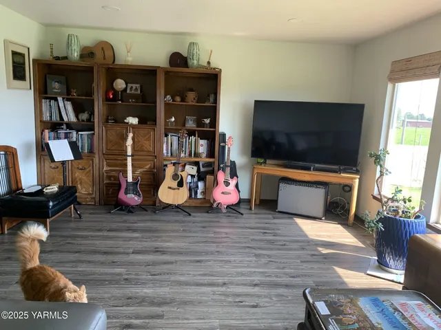 a living room with lots of furniture and a flat screen tv