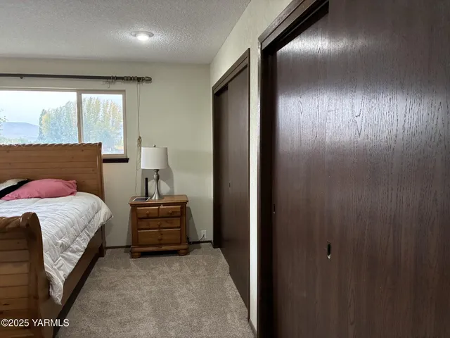 a bedroom with a bed and a large window