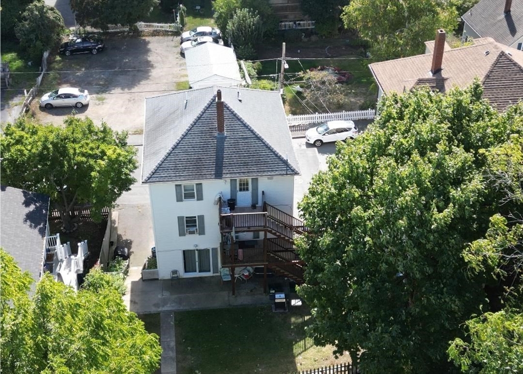 52 Taylor Street Gloucester, MA 01930 - Photo 2 of 12 an aerial view of a house with yard and trees in the background