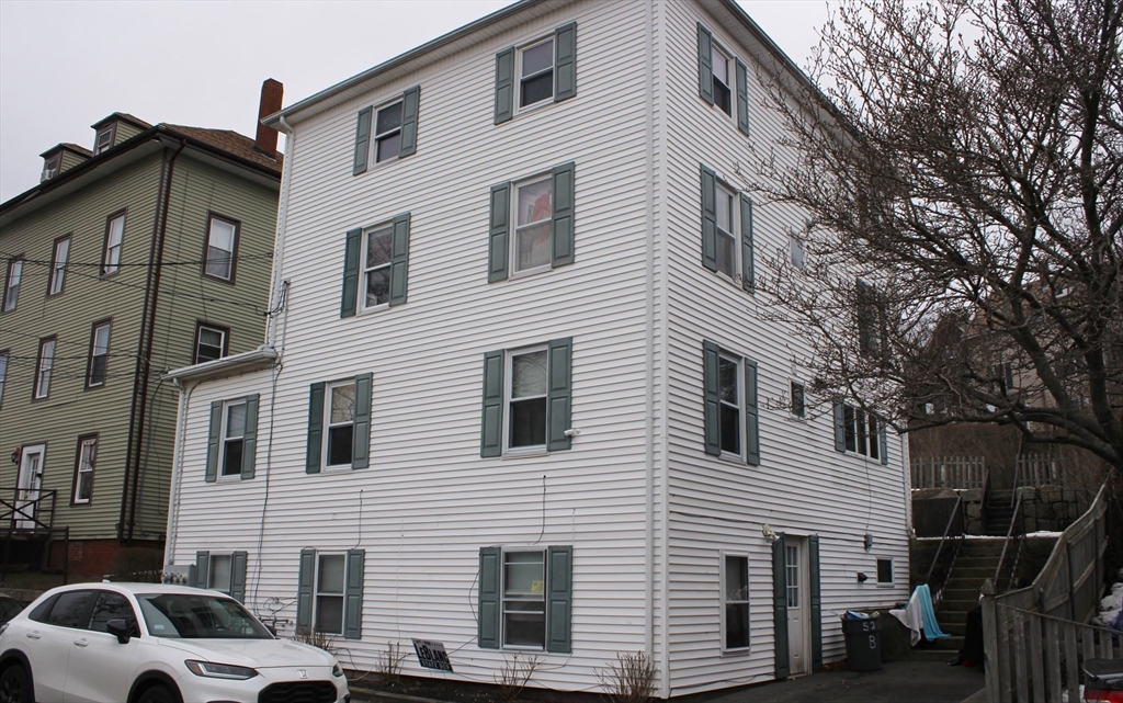 52 Taylor Street Gloucester, MA 01930 - Photo 3 of 12 a view of a house with a car park side of road