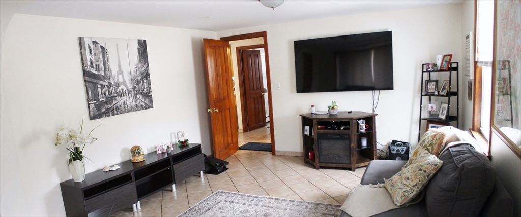52 Taylor Street Gloucester, MA 01930 - Photo 5 of 12 a living room with furniture and a flat screen tv