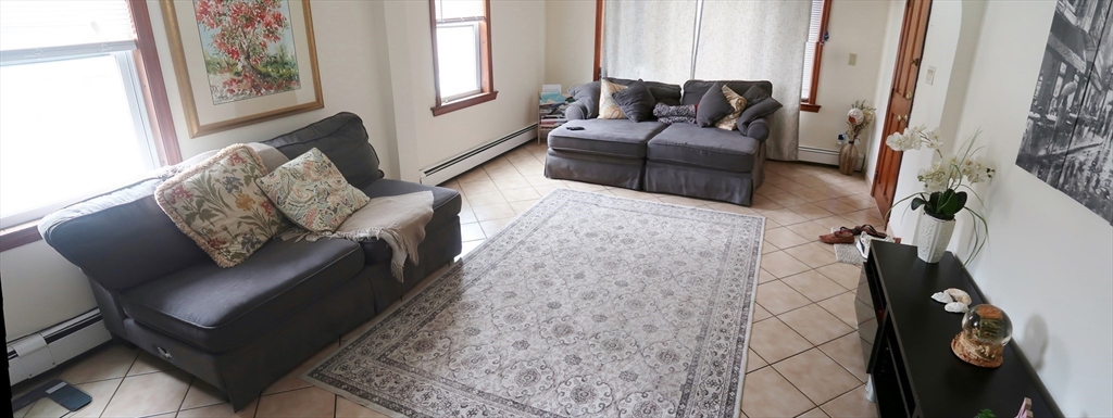 52 Taylor Street Gloucester, MA 01930 - Photo 8 of 12 a living room with furniture and a couch