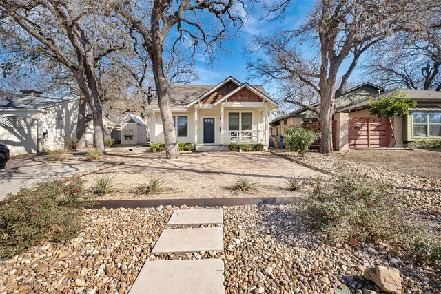 a front view of a house with a yard covered in snow