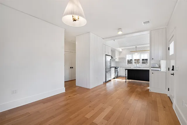 a kitchen with stainless steel appliances a refrigerator and a stove top oven