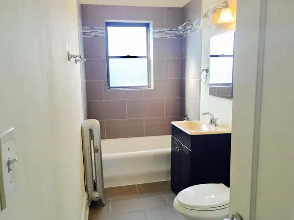 a bathroom with a sink a toilet and tub